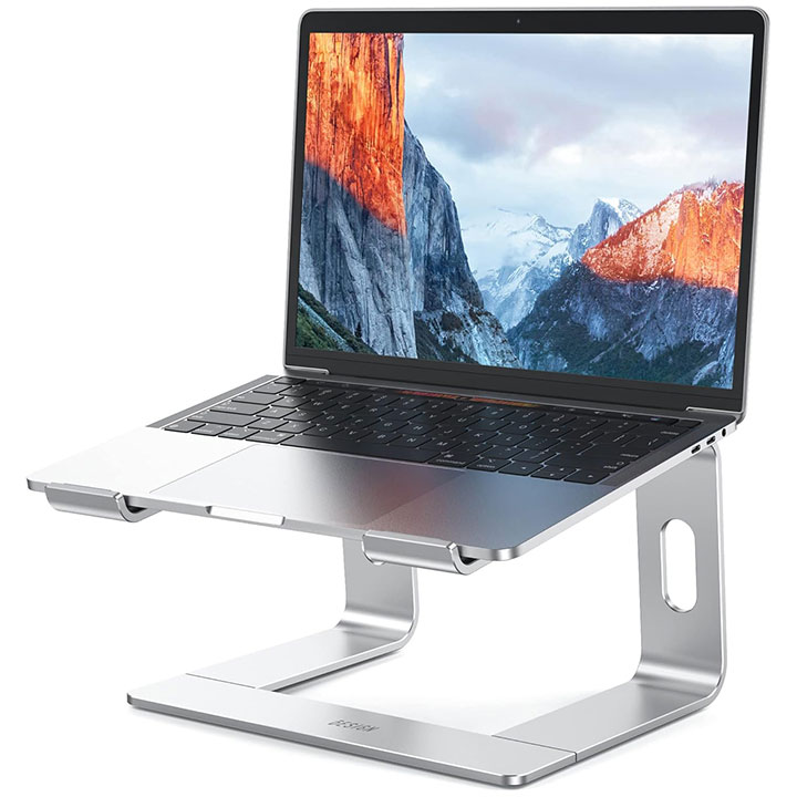 A stand that's placed under a laptop to elevate it off of a surface with a slight forward downward angle
