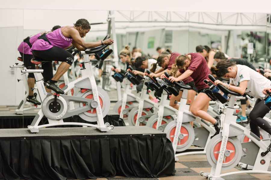 LMU instructor and students riding the stationary bikes.