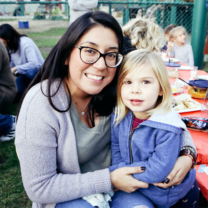 A teacher sitting with a student outside